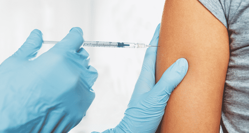 Person taking vaccine in arm