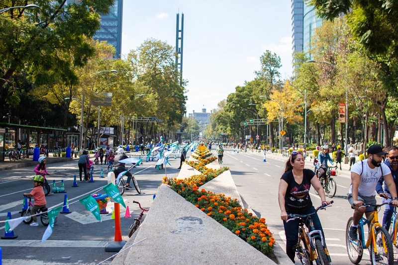 People riding bicycles on Paseo de La Reforma Avenue in Mexico City